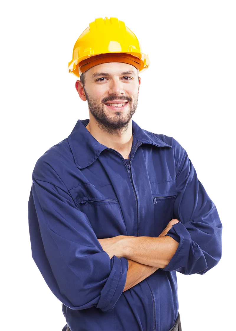 Smiling construction worker in a yellow hard hat and blue coveralls