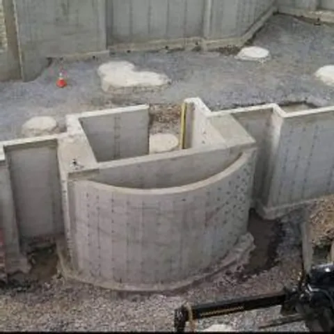 Poured concrete foundation walls with a curved bay section