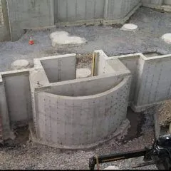 Poured concrete foundation walls with a curved bay section