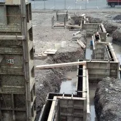 Aluminum wall forms set along footings for a poured foundation