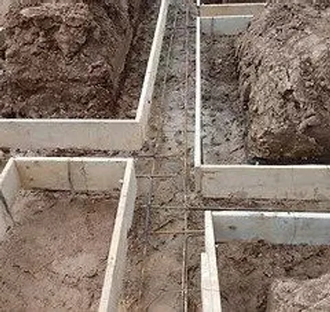 Wood footing forms with rebar set in excavated trenches