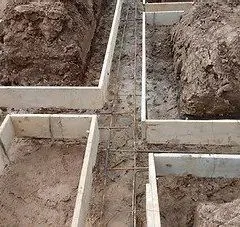 Wood footing forms with rebar set in excavated trenches